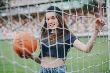 girl standing next to a net