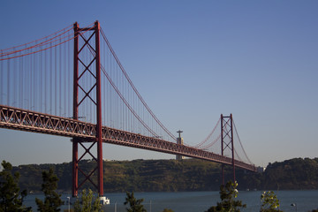 Fototapeta na wymiar Bridge over river and King Christ in the background