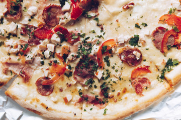 Italian pizza with cheese,ham,salami,mushrooms and tomato, Traditional beked cuisine bread,pie,sliced, tasty dinner