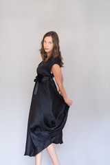 Fototapeta premium woman in a black dress isolated on white background