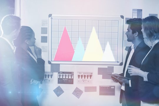 Composite image of business team working on graph