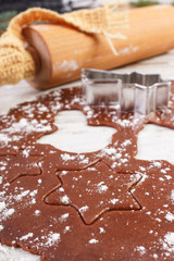 Dough and accessories for Christmas cookies or gingerbread on old rustic board