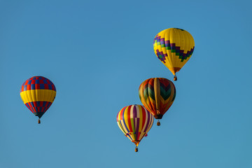 Colorful hot air balloons against blue sky