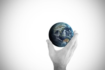 Composite image of hand presenting little earth