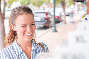 Young woman shopping for cloths outside