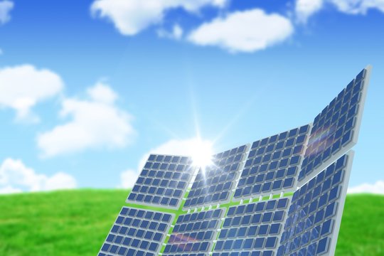 Composite image of modern solar equipment against landscape
