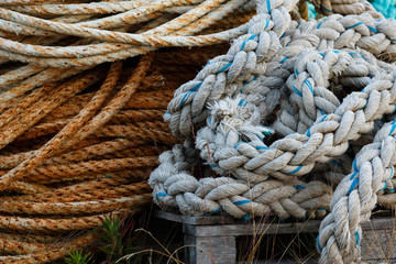 Old ropes on the wharf close up