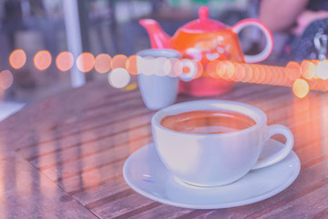 Abstract soft blurred and soft focus a cup of cappuccino, hot coffee with the bokeh, beam light, lens flare effect tone background.