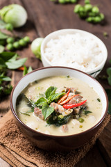 Thai food (Kaeng Khiao Wan),Green curry with pork and cooked rice on wooden background