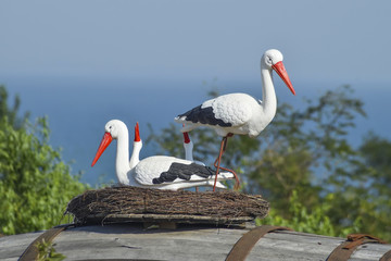 Toy nest of a stork with birds on it