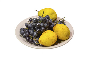 Yellow pear and grapes on the plate