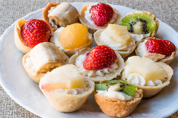 Mini Tarts, Tartolet or Tartlets with cream and fresh fruits