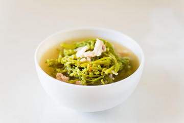 Northern Thai food (Kaeng Puk Plung),Ceylon spinach soup with pork in a bowl on white background.Traditional and local food