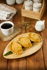 delicious curry puffs on wooden plate