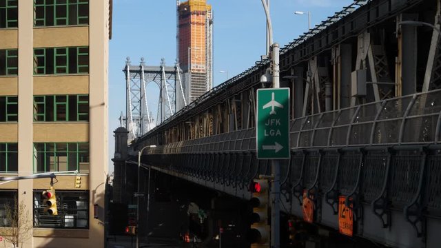 A daytime side profile exterior establishing shot (DX) of the Manhattan Bridge.  	