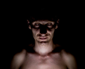 Stylish dark portrait of caucasian man who looks straight at you and looks like maniac. Expressive...