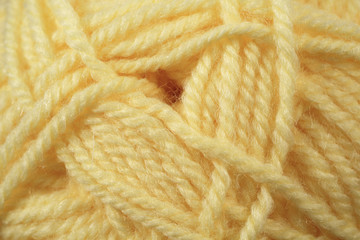 A super close up image of yellow colored yarn