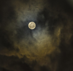 Naklejka na ściany i meble Moon on a cloudy night sky