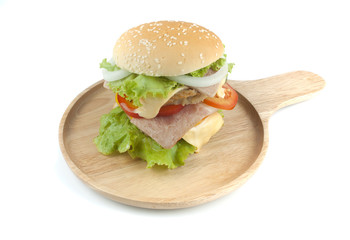 Pork hamburger Homemade with grilled bacon contains vegetables, cheese, lettuce, onion, chilli, spices in a wooden dish isolated on white backgroud