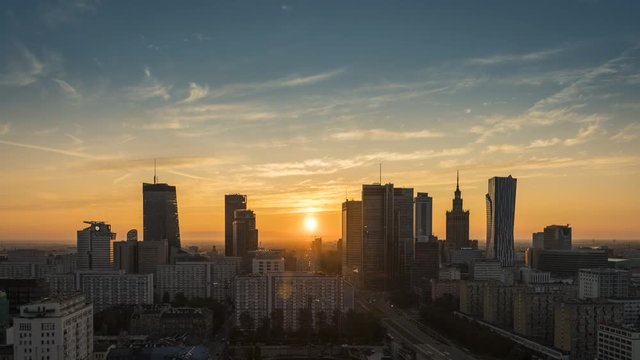 Sunrise over Warsaw downtown skyline with skyscrapers, Poland. Time lapse at dawn