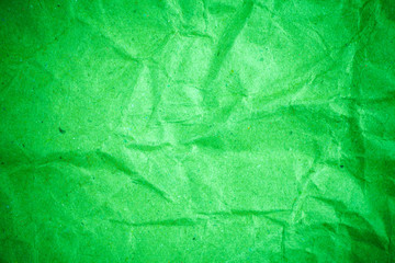 Green vignette crumpled paper.