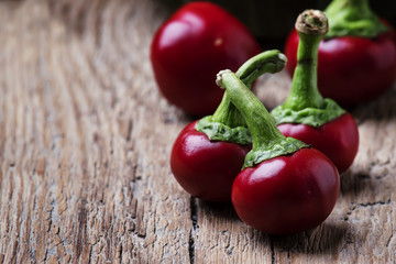 Small spicy red pepper, vintage wooden background, selective focus