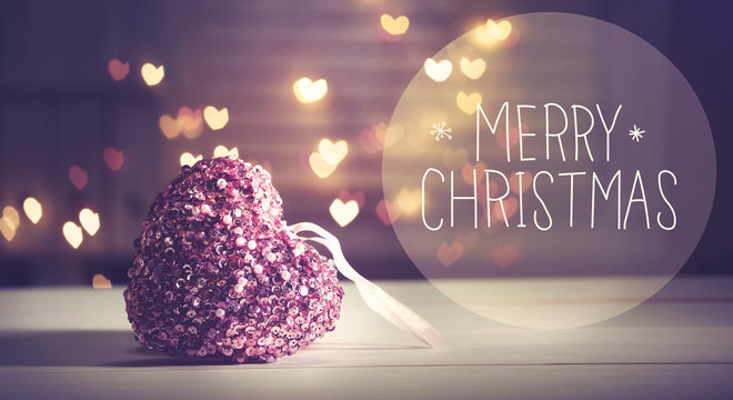 Merry Christmas message with a pink heart with heart shaped lights
