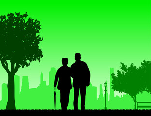 Lovely retired elderly couple walking with umbrella in park in autumn or fall, one in the series of similar images silhouette