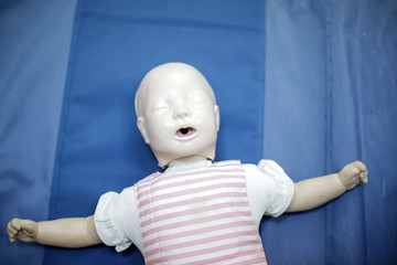 CPR training medical procedure - Demonstrating chest compressions on CPR doll