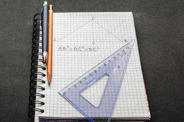 Page with formulas and the Pythagorean theorem with pen, pencil and ruler