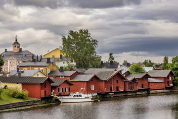 Fototapeta na wymiar Beautiful view of the old town of Porvoo, Finland, Uusimaa region, with a boat moored near the colorful wooden houses on the river Porvoonjoki