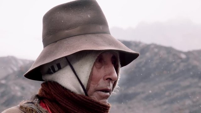 Native quechua man using a chullo and a highlander hat. Peru. Slow motion