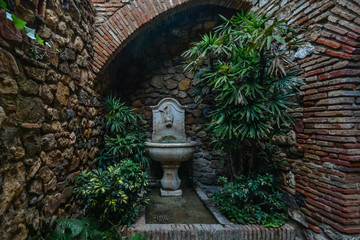 Patio with fountain and plants. Detail of the interior of the Alcazaba arab castle in Malaga, Spain.