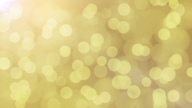 Holiday light yellow shining background. Seamless loop abstract image.