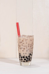 Boba / Bubble tea. Homemade Chocolate Milk Tea with Pearls on wooden table.