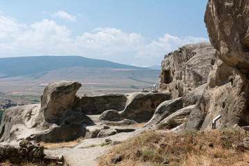 Fototapeta na wymiar Dwellings, hewn in solid rocks in Uplistsikhe, ancient underground town of Georgia