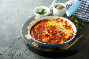 Eggs with spices, herbs and tomato sauce