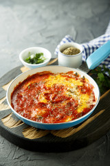 Eggs with spices, herbs and tomato sauce