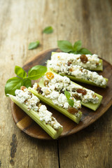 Celery appetizer with cream cheese and dried fruits