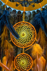 Fototapeta na wymiar Dreamcatcher made of feathers, leather, beads, and ropes