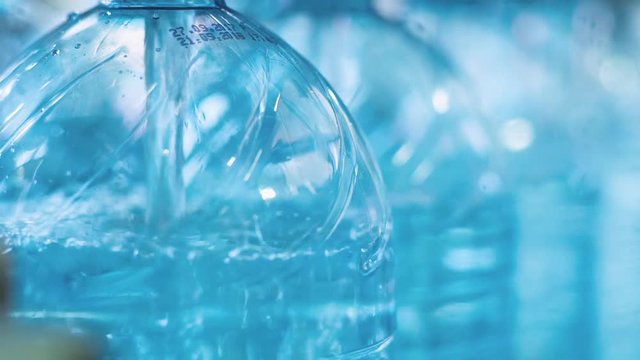 Production line of drinking water and carbonated drinks, the process of filling bottles with water, conveyor.
