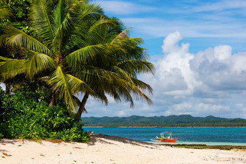 Tropical Guyam Island with traditional fishing boats