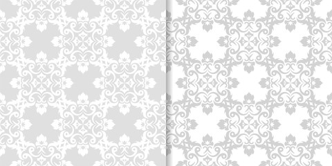 Light gray floral backgrounds. Set of seamless patterns for textile and wallpapers