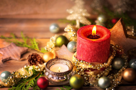 Christmasbackground, advent decoration with burning candles on rustic wooden table