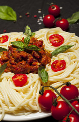 Closeup of delicious spaghetti Bolognaise or Bolognese with savory minced beef and tomato sauce.