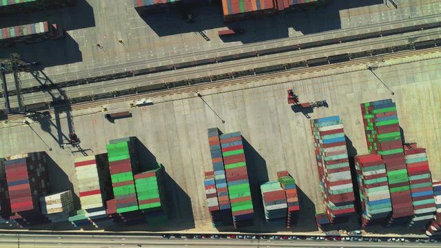 Aerial birds eye view of stacked containers at a trading port.