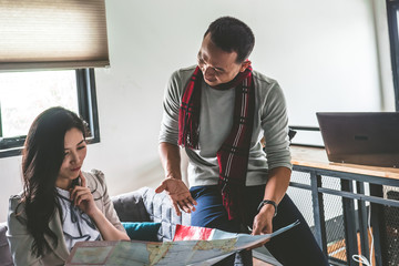 Two Travelers planning vacation and looking at the map. Travel concept.