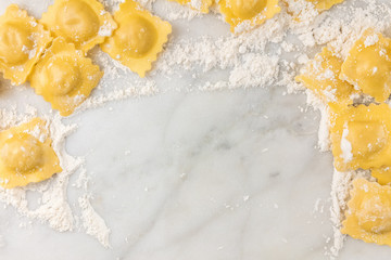 Overhead photo of ravioli with flour and copy space