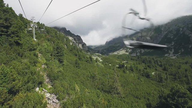 Ski-lift cable car leading to Predne Solisko peak of Tatra mountains, Slovakia. Beautiful summer landscape with canyon and green pine tree forest. Sport lifestyle, holiday, travel, recreation. Full HD