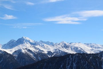 Background of blue sky over  snow-capped mountains